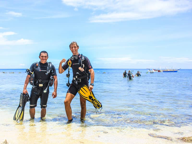 Divemaster coming out of the water with discover scuba participant